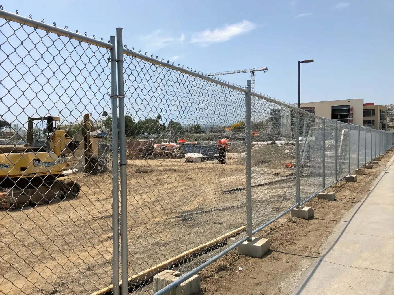 Galvanized chain link fence being installed on a residential property